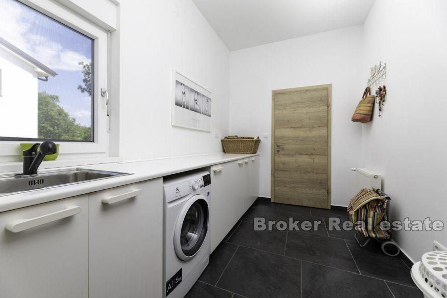 Modern house with a swimming pool on the edge of the green zone