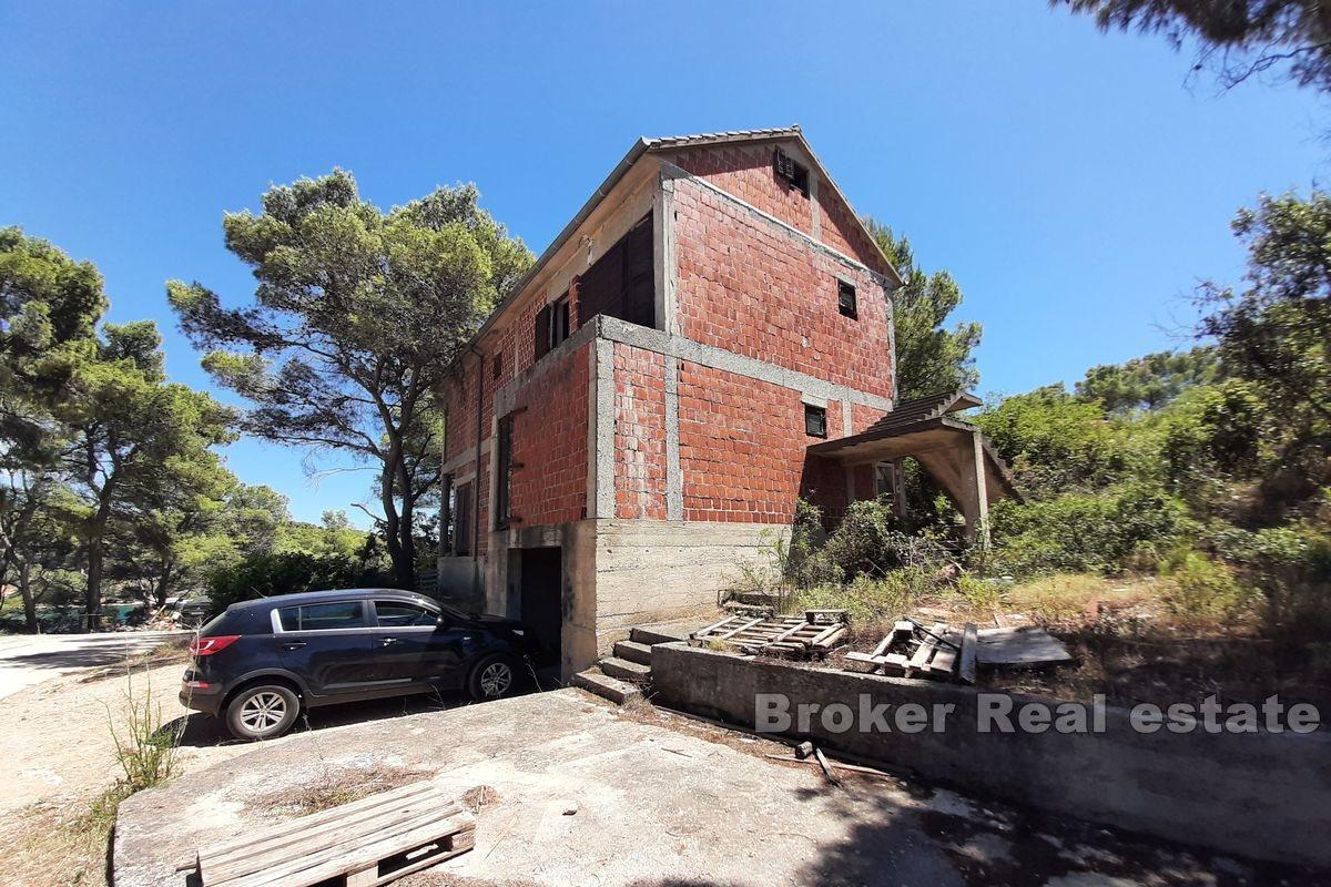 Unfinished apartment house in the first row from the sea