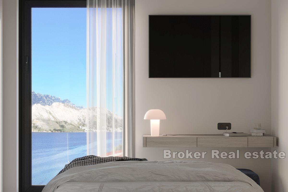 Modern apartments in a new building with a pool and a view of the sea