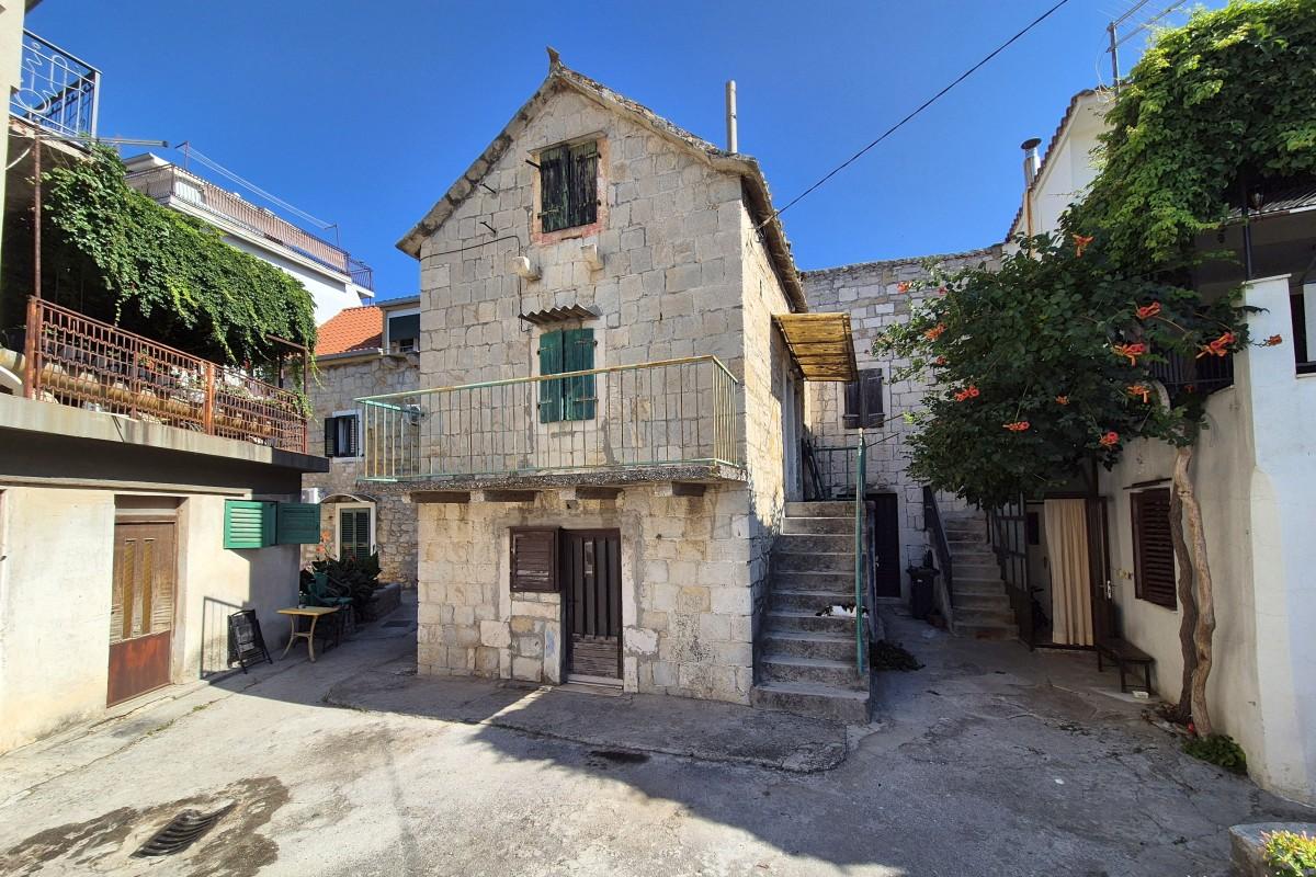 Stone house for renovation with garden in the first row to the sea