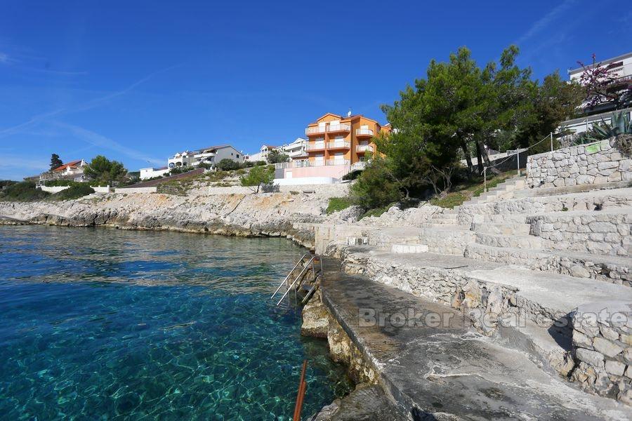 Apartment house with pool first row to the sea