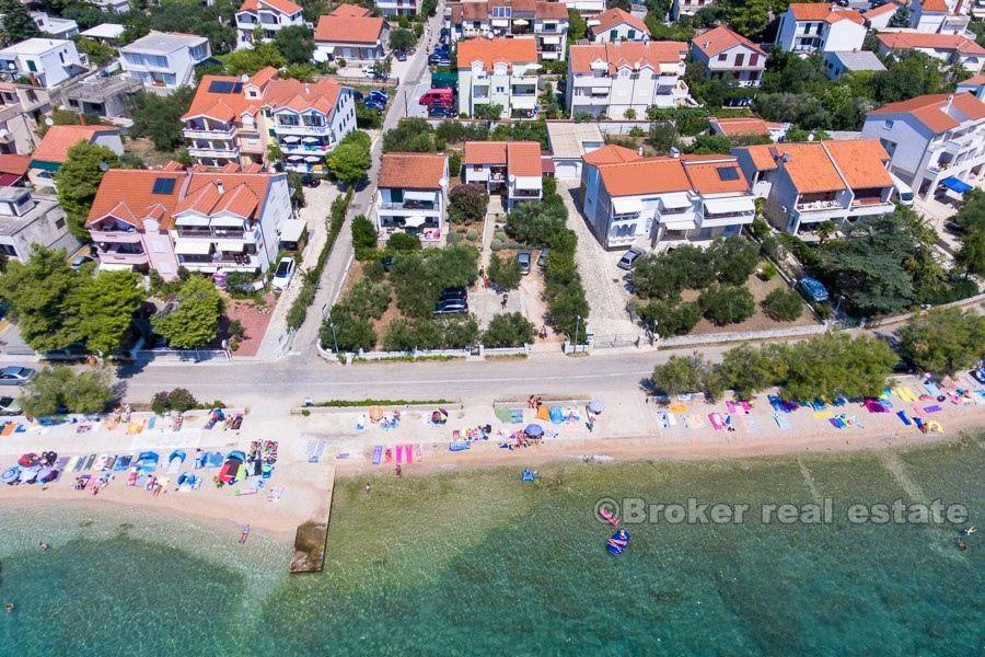 Two houses on a larger plot, by the sea, for sale.