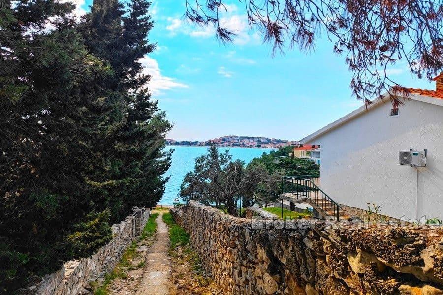 Building plot with a house near the sea