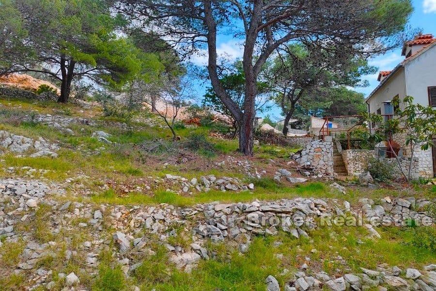 Building plot with a house near the sea