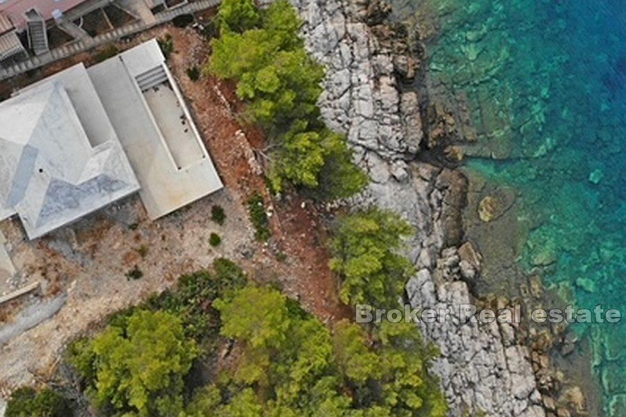 Unfinished house with pool, first row to the sea