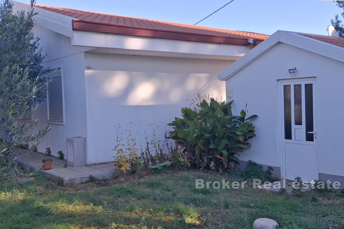 Building land with three apartments in the first row to the sea