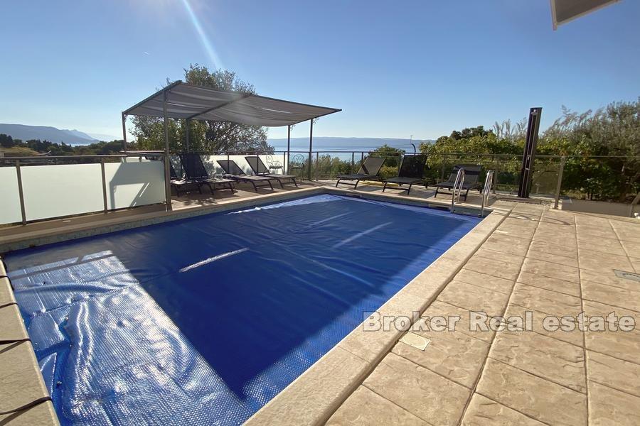 House with a pool and sea view