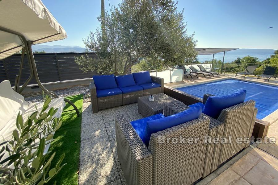 House with a pool and sea view