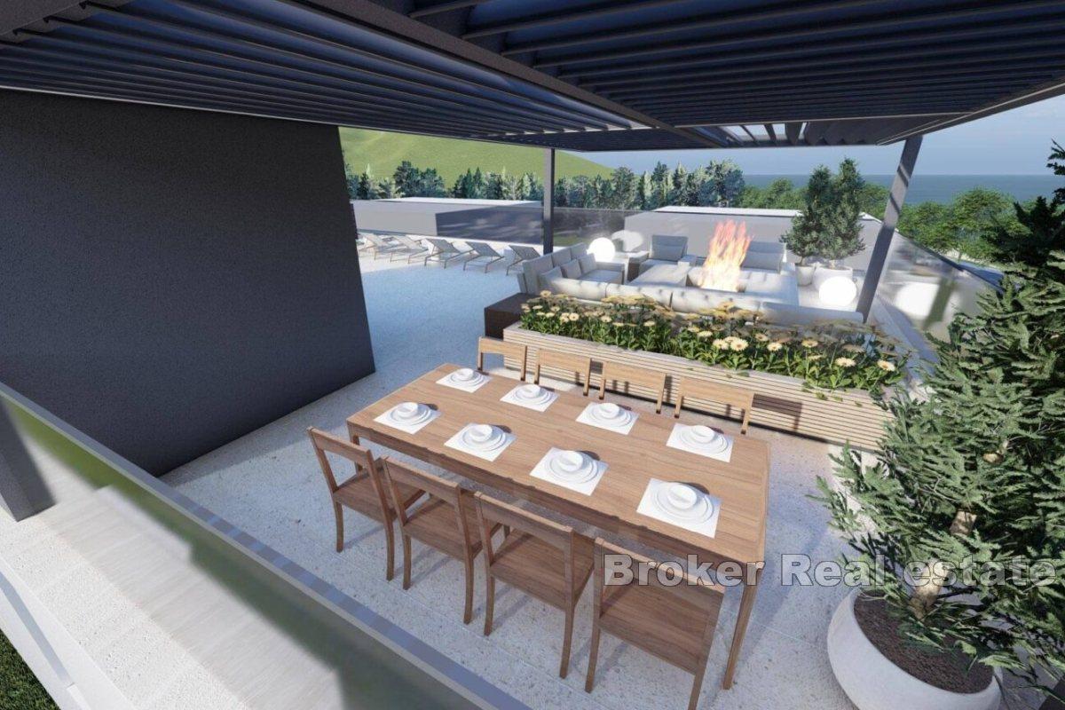 New construction with a roof terrace in the first row to the sea