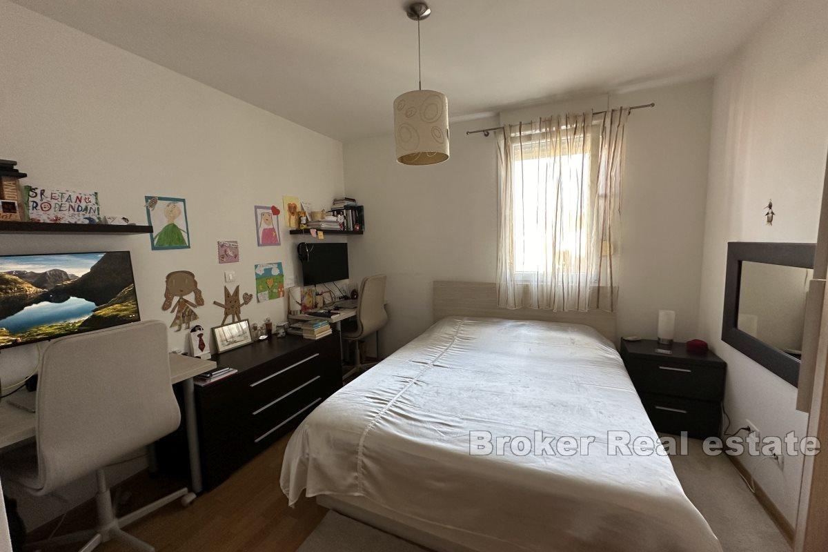 Two-bedroom apartment with three garage spaces and a view of the sea