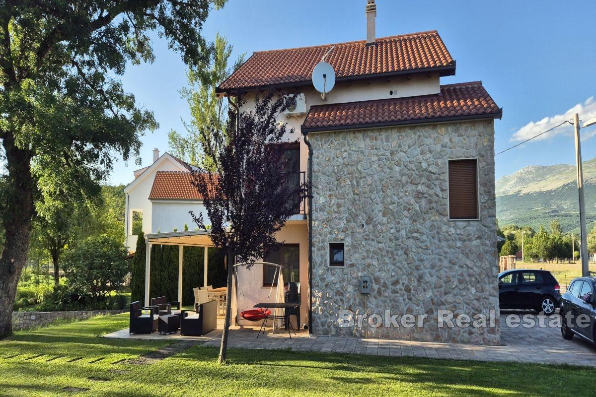 Detached house by the river with a pool and landscaped garden