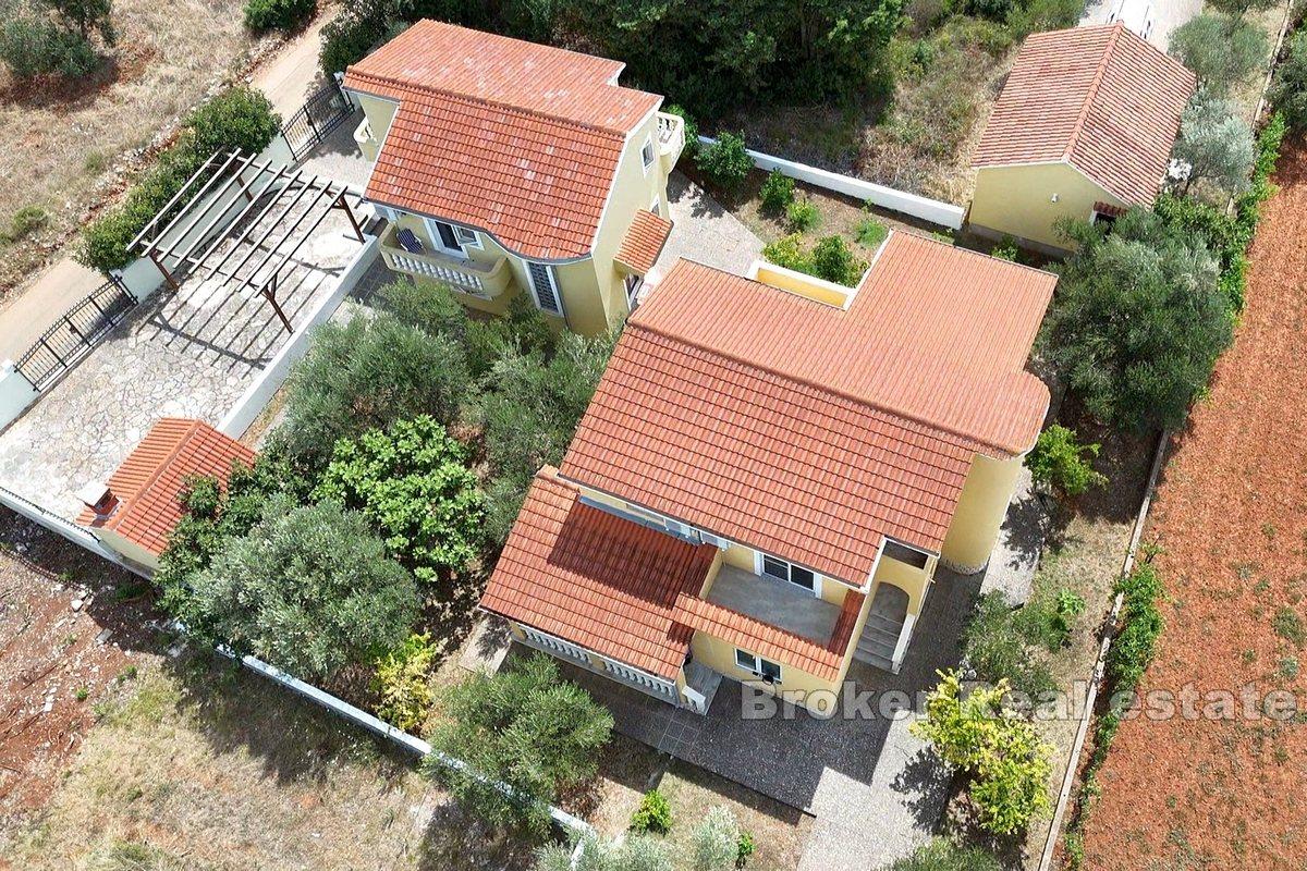 Two detached houses with a large garden