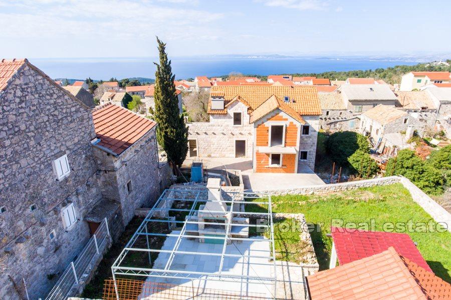Stone house in a row with sea view